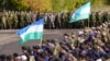Militari mobilizați din Bașkortostan (cu steaguri ale regiunii) la locul de adunare în regiunea Saratov, în octombrie.