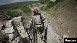 Nagorno-Karabakh -- Ethnic Armenian soldiers walk in a trench at their position near Nagorno-Karabakh's boundary, April 8, 2016