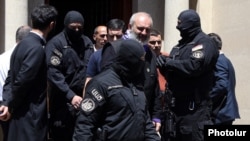 National Security Service officers are seen arresting Archbishop Bagrat Galstanian in Armenia's capital, Yerevan, on June 25, 2025.