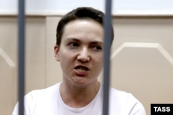 Nadiya Savchenko stands inside the defendant's cage during her hearing in the Basmanny district court in Moscow on November 11.
