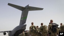 Afghanistan -- U.S. soldiers walk to get in to a U.S. military plane, as they leave Afghanistan, at the U.S. base in Bagram, north of Kabul, 14Jul2011