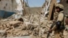 File photo of a Pakistani soldier standing near the debris of a house destroyed during a military operation in the town of Miranshah in North Waziristan.