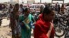 Relatives of victims arrive at the site of a deadly attack on a bus in Karachi that was carrying members of the Shi'a community. 