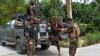 Forces with Afghanistan's National Directorate of Security (NDS) escort alleged Taliban and Islamic State fighters after they are presented to the media in Jalalabad on May 23.