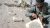 An Afghan policeman points to a mark on a landmine found in Ghurian district in Herat Province (file photo)
