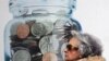 Greece -- A passerby walks by a bank's promotional poster advertising the interest rates for its savings account, Athens, 12Feb2010
