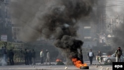 Supporters of opposition party, Tehrik-e Insaf burned tyres during a protest in Karachi on December 12.